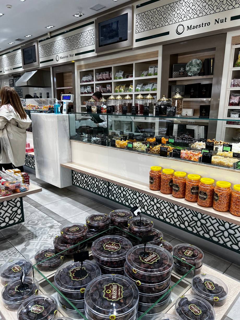 Maestro Nut storefront with display case of nuts and jars, shelving with products