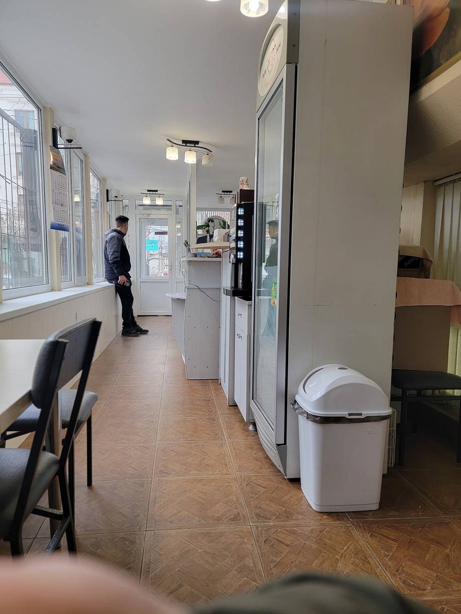 Modern office or business space with open layout, light fixtures, and commercial furniture
