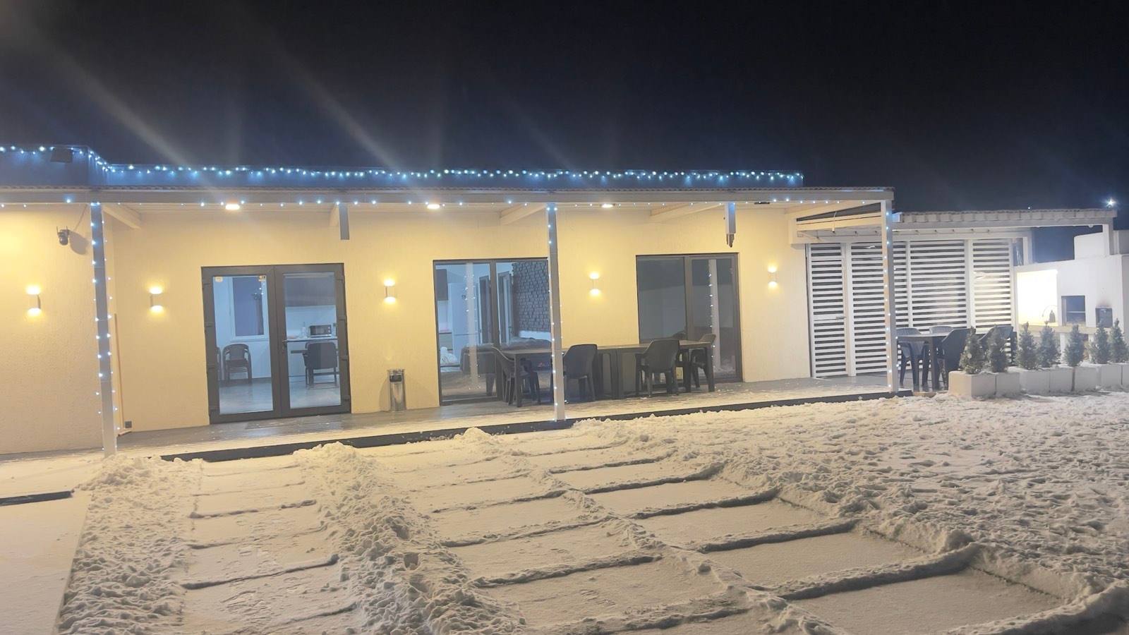 Beachfront venue pavilion with modern yellow exterior and evening ambient lighting