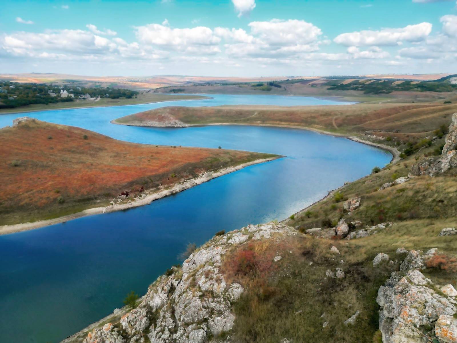 Panoramic aerial view of pristine blue lakes surrounded by rolling hills and natural landscape