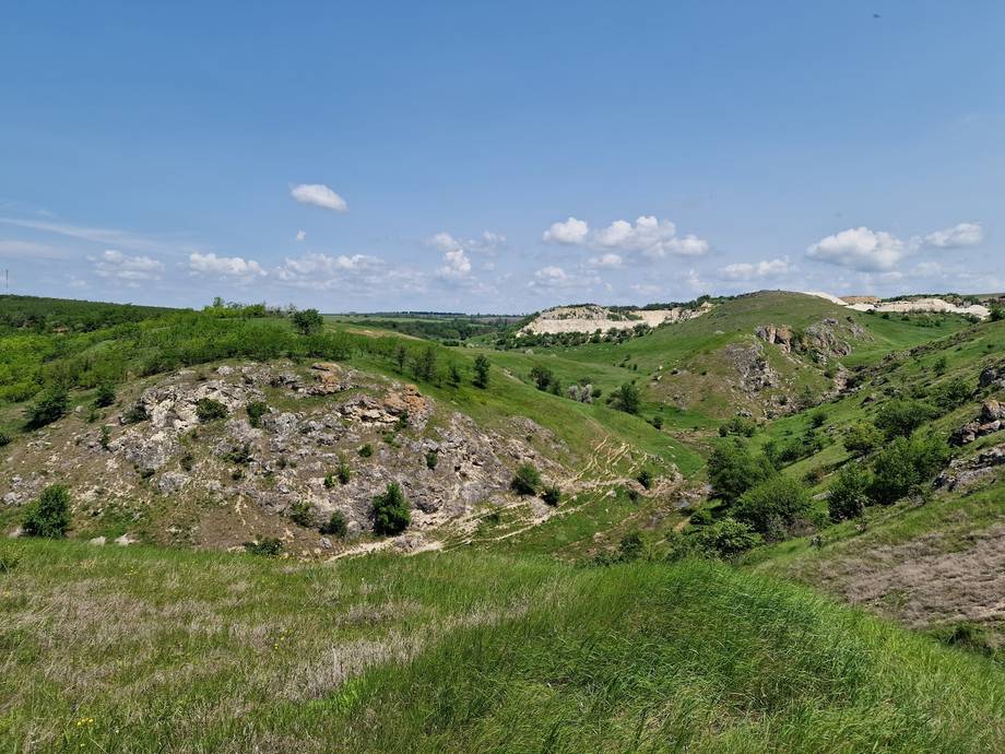 Rolling hillside with distinctive rocky outcrop formations typical of Moldova landscape