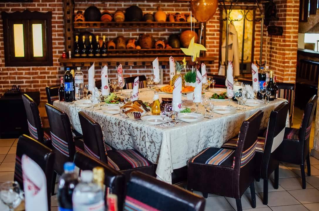 Elegant reception room with exposed brick walls, wine display, and formally set dining table