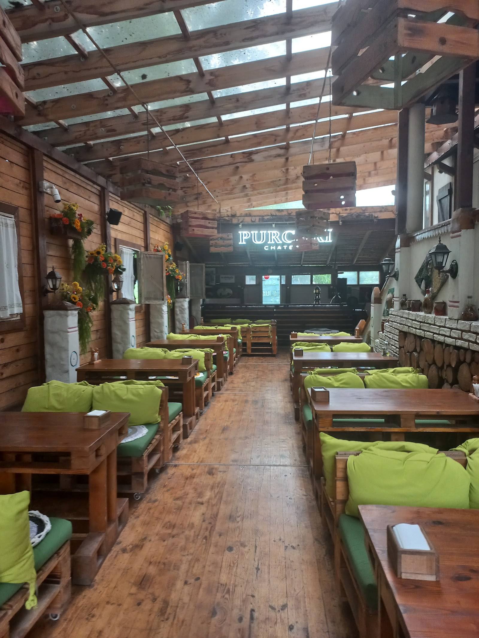 Rustic pub interior with wooden tables, lime green cushions, and industrial ceiling