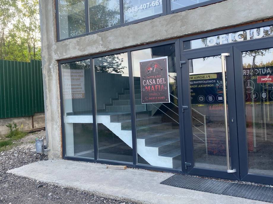 Modern storefront with "Casa del" signage, contemporary glass entrance and black facade