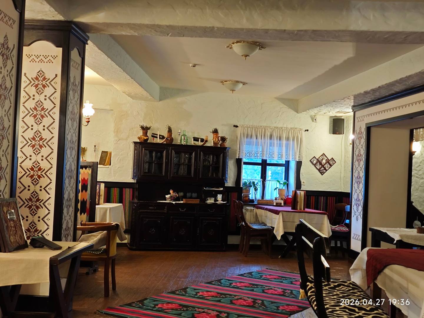 Traditional interior with dark wooden furniture and ethnic textiles in a cultural venue