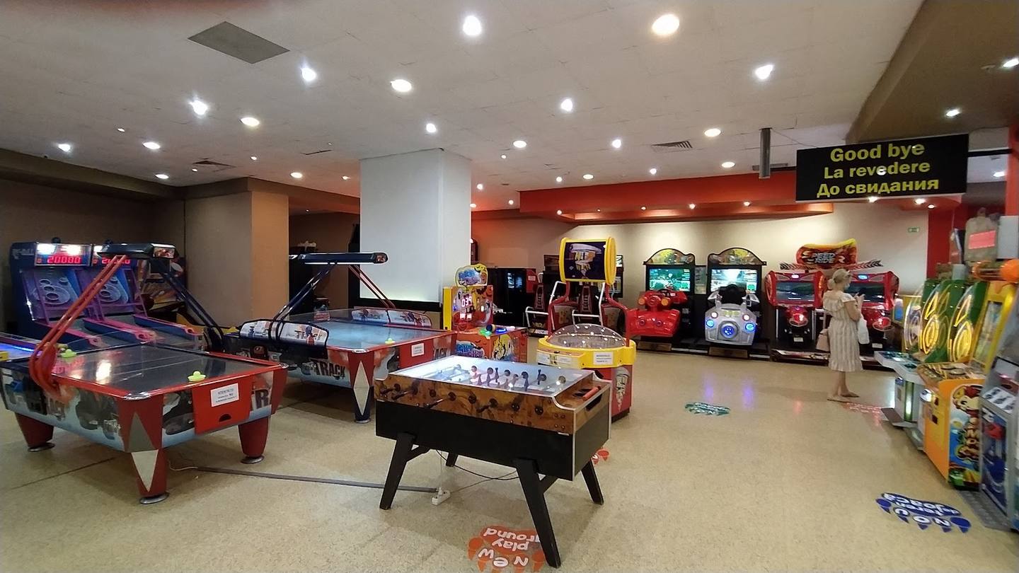 Game room with arcade machines, pool table, and air hockey in spacious recreational hall
