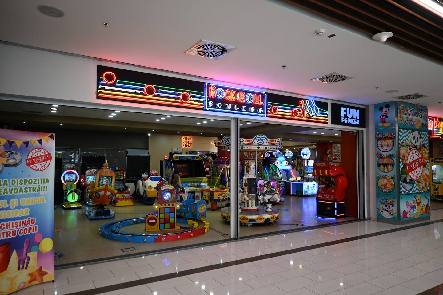 Bright children's play center with colorful games, rides and attractions visible through storefront glass