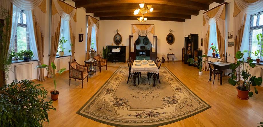 Historic monastery reception hall with wooden beams and period furnishings