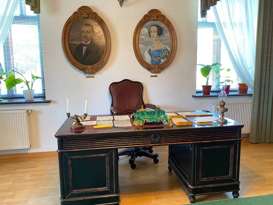 Historic period desk with portraiture and natural light from windows
