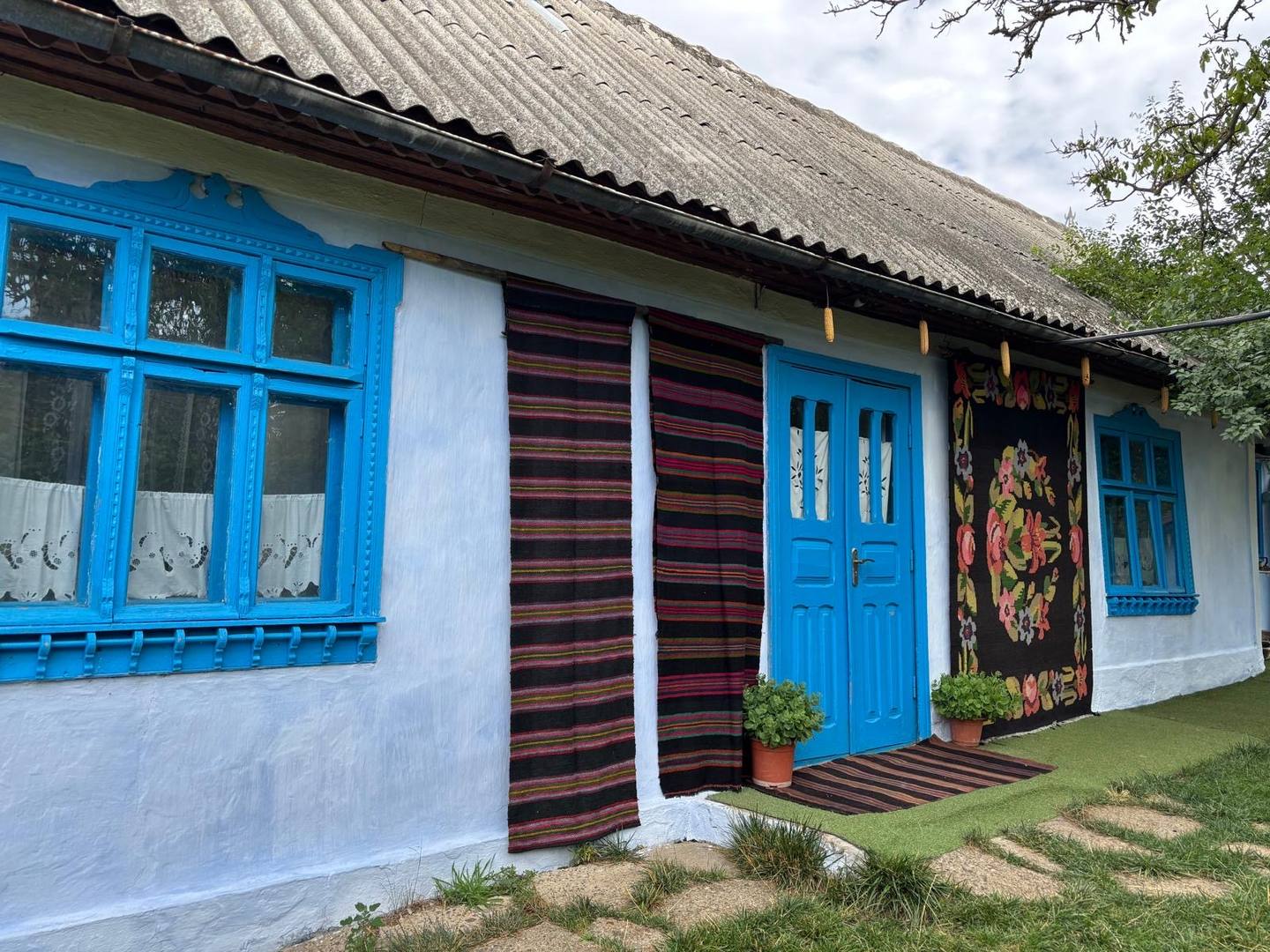 Historic blue-trimmed cottage exterior with traditional architectural details