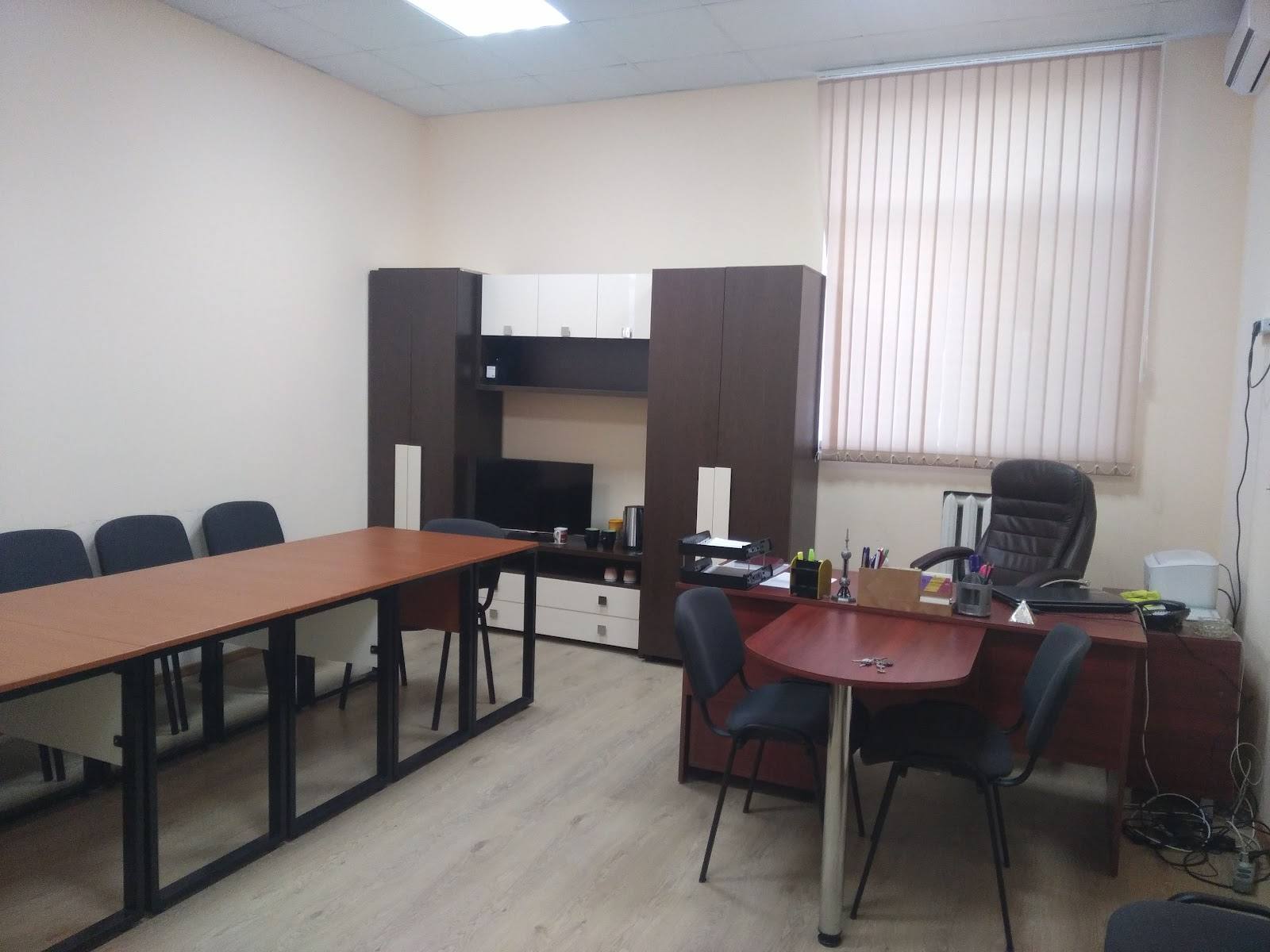 Office workspace with two desk areas and partition divider