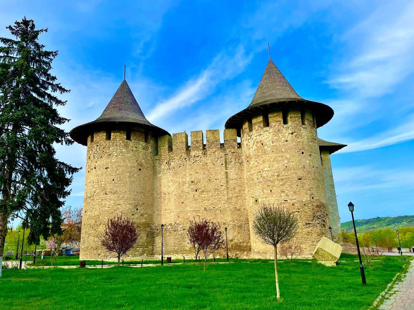 Medieval fortress with twin towers and stone walls under blue sky