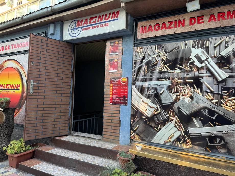 Storefront of Magazin de Arme (weapons/arms shop) with brick facade and signage