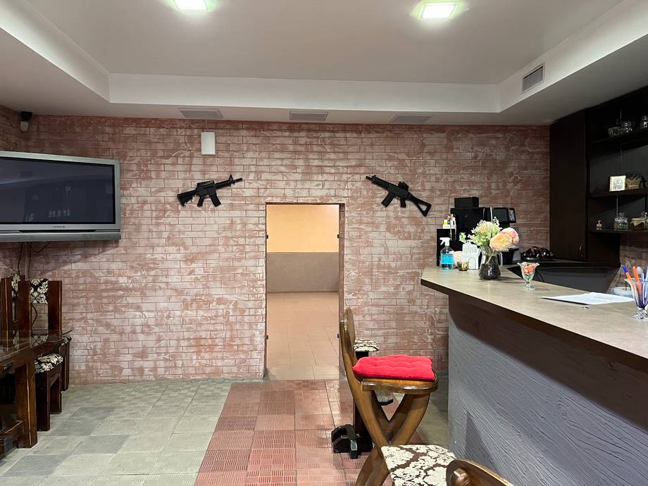 Modern interior reception area with exposed brick wall and checkout counter