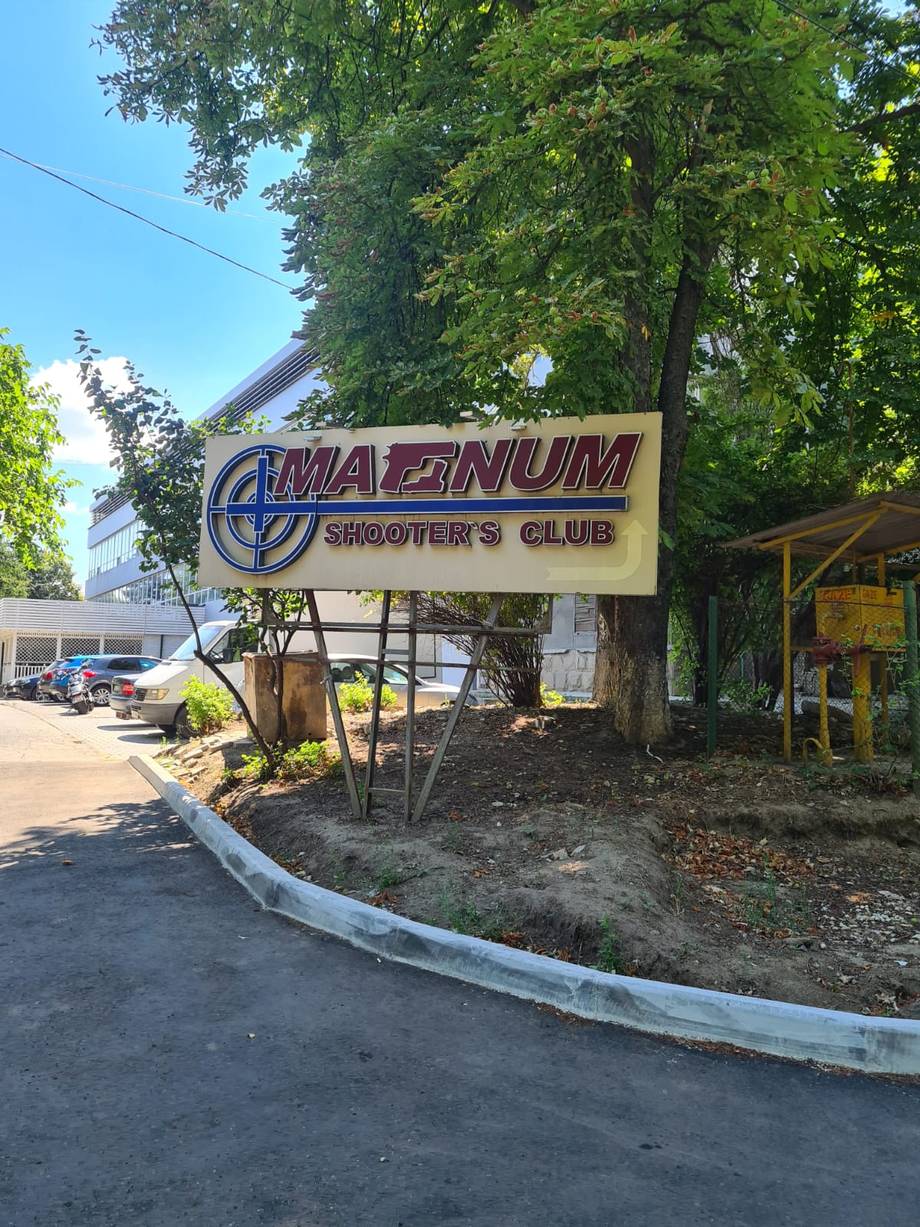 Amazonium Shooters Club storefront and entrance sign with parking area