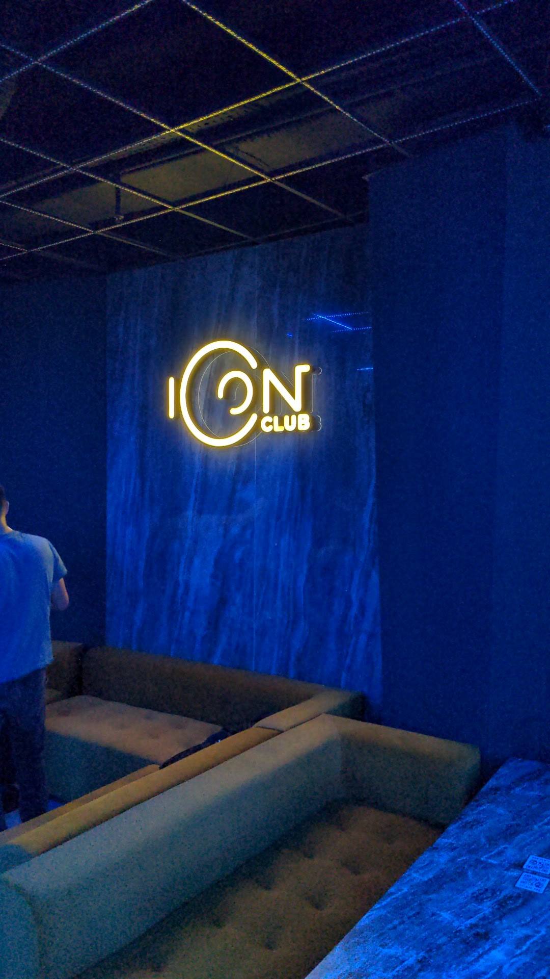 ION Club neon sign with blue ambient lighting and lounge seating