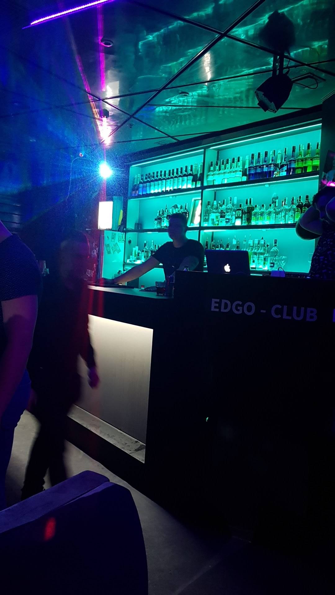 EDGO Club bar counter with illuminated bottle display and neon ambient lighting