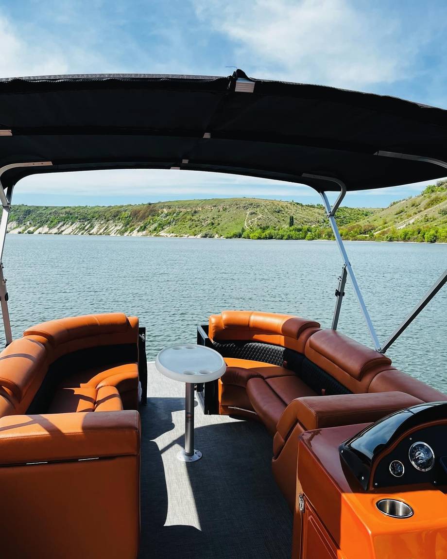 Luxury boat interior with lake and hillside backdrop
