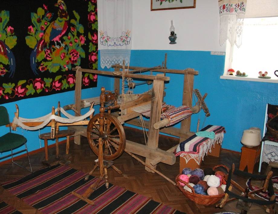 Traditional wooden loom with weaving craft supplies in a cultural workshop space