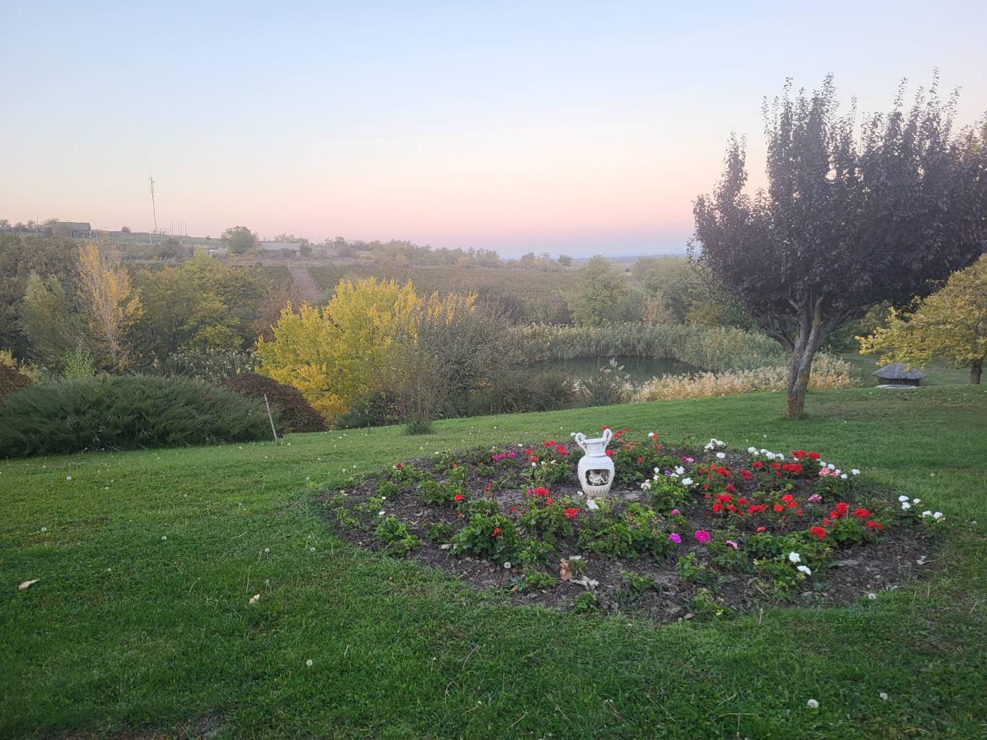Landscape garden with flowering beds and countryside views at golden hour