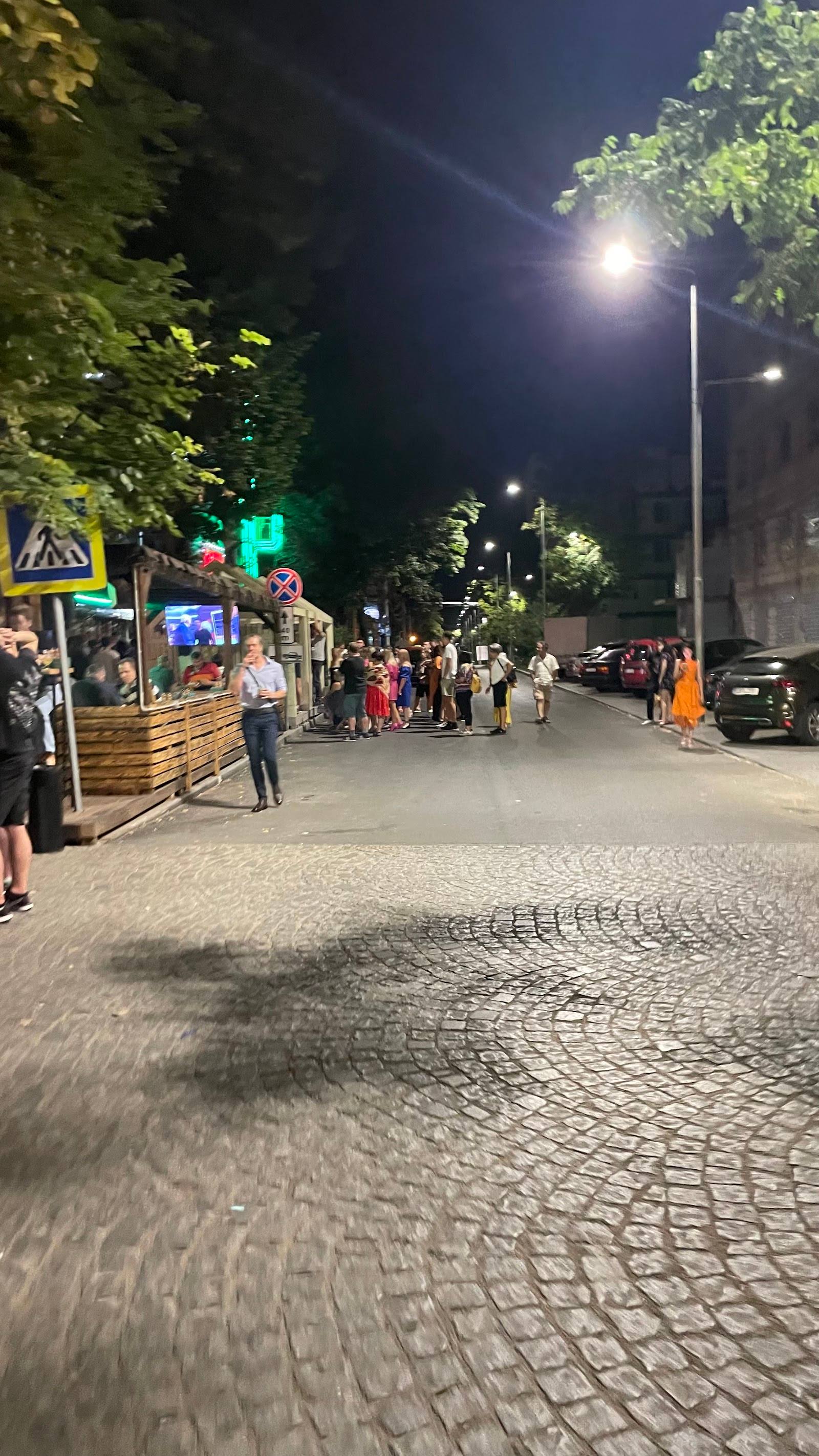 Evening street scene with pedestrians and outdoor vendors in Moldova