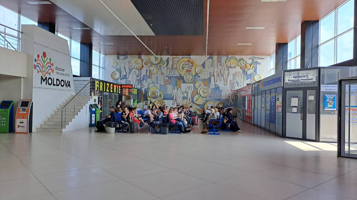 Modern terminal interior with seating area and Moldova branding visible