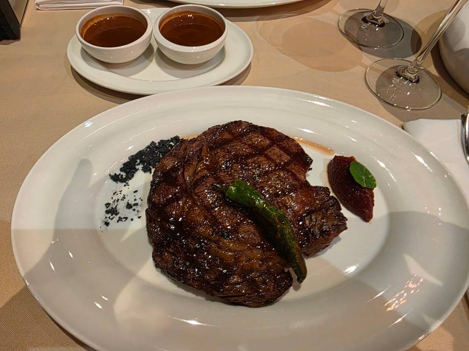 Grilled steak with herb garnish and coffee service