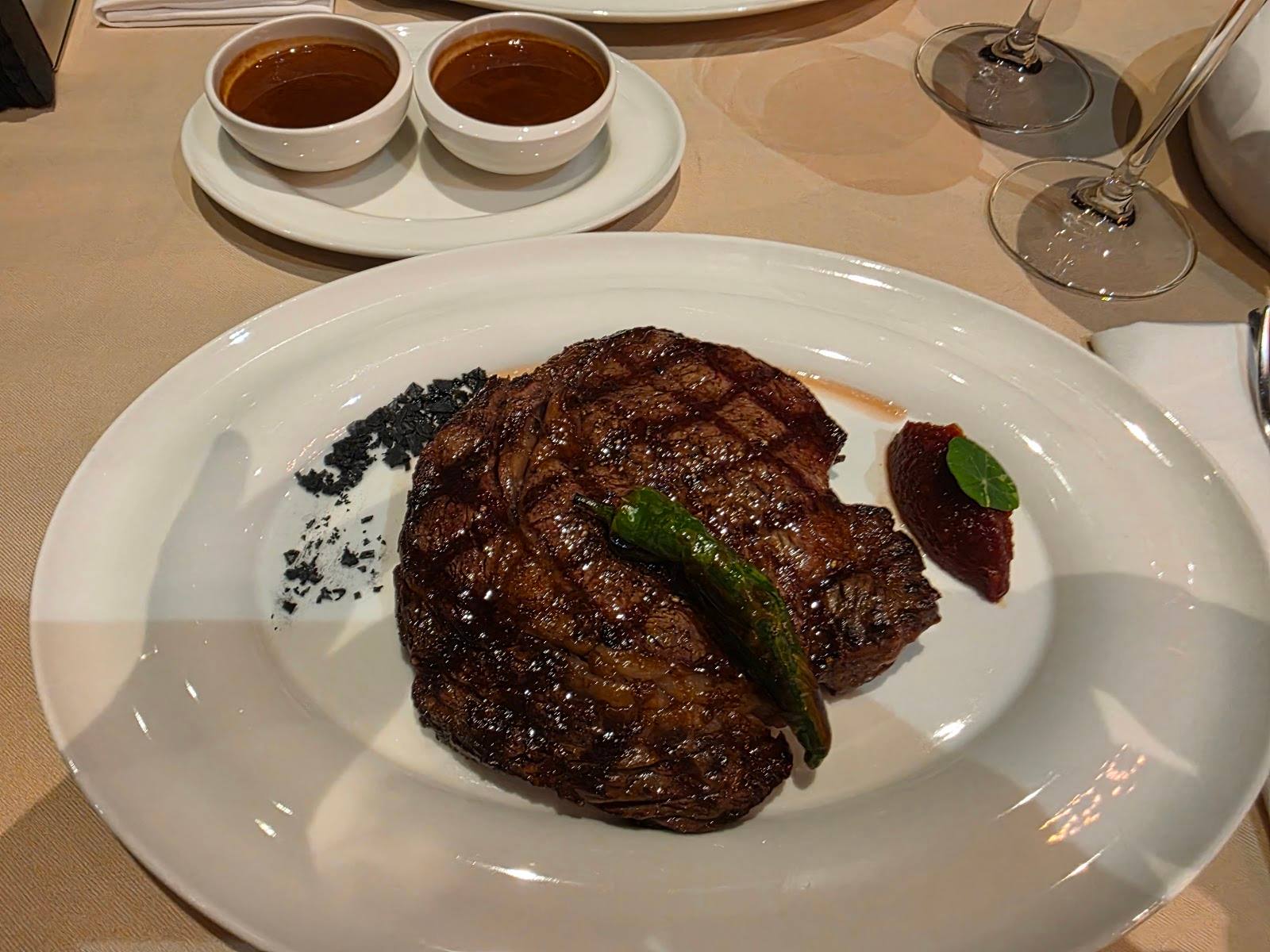 Grilled steak with herb garnish and coffee service