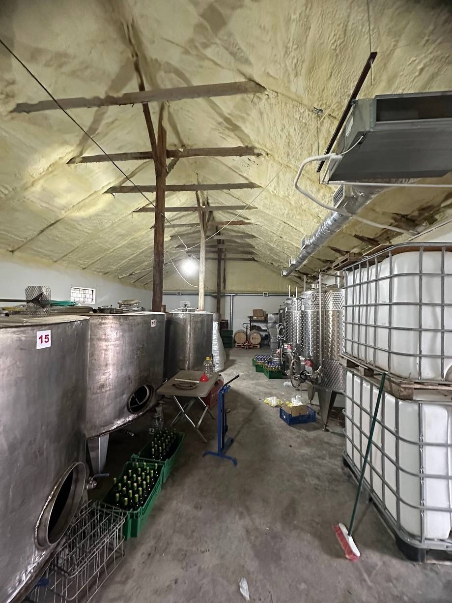 Wine production facility with fermentation tanks and industrial equipment