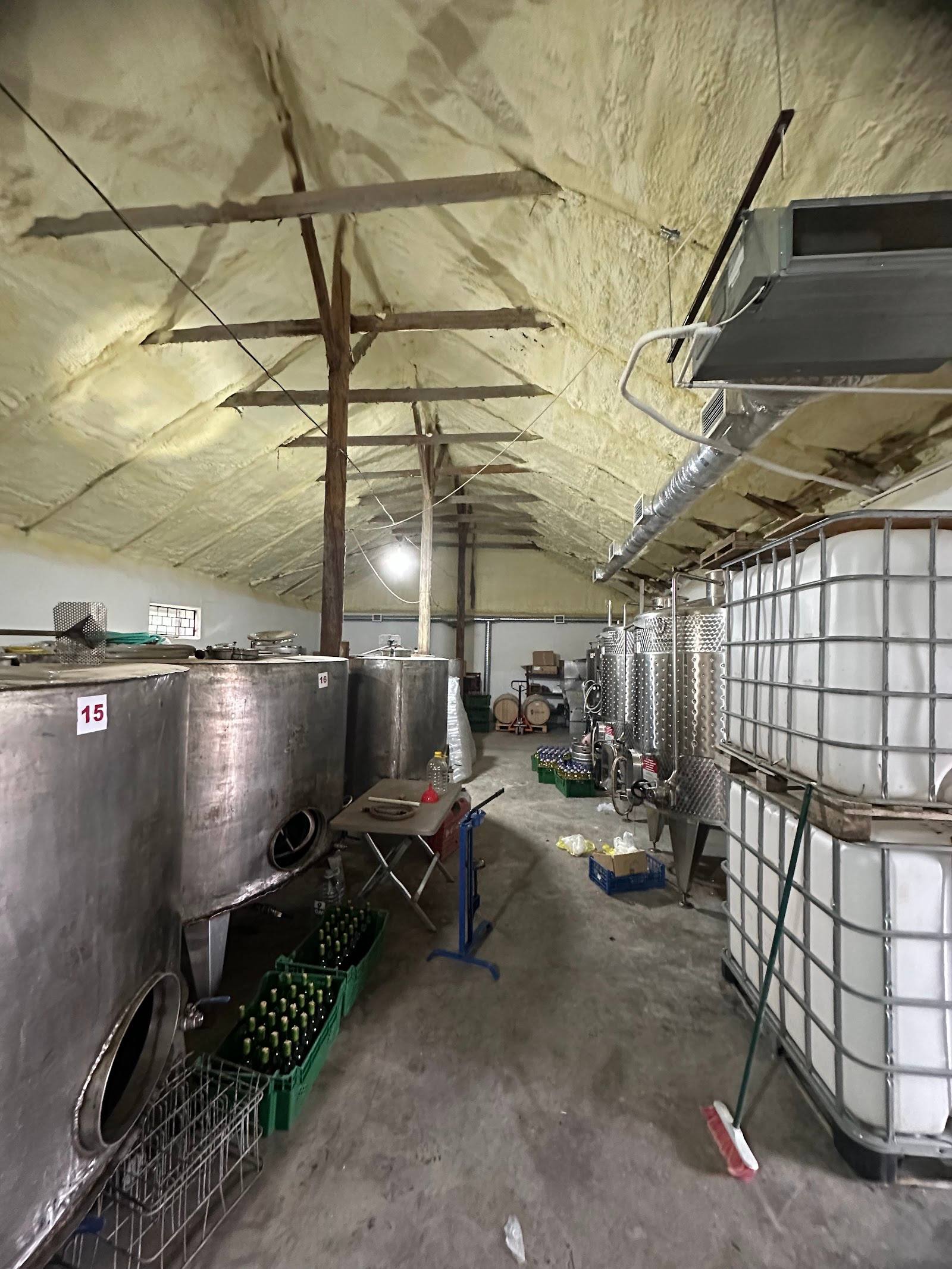 Wine production facility with fermentation tanks and industrial equipment