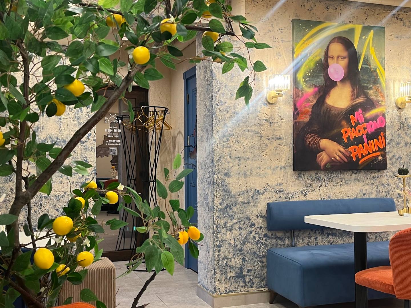 Modern cafe interior with decorative lemon tree and pop art wall mural
