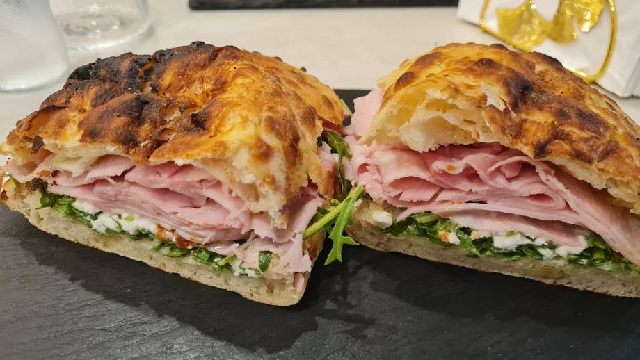 Ham and cheese croissant sandwich on slate platter