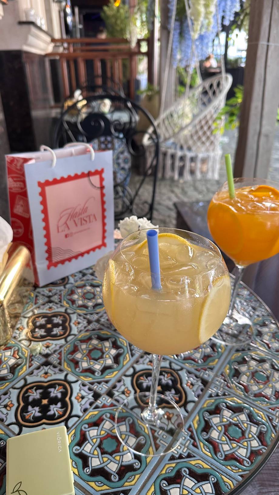 Signature cocktail with lemon citrus at outdoor terrace venue