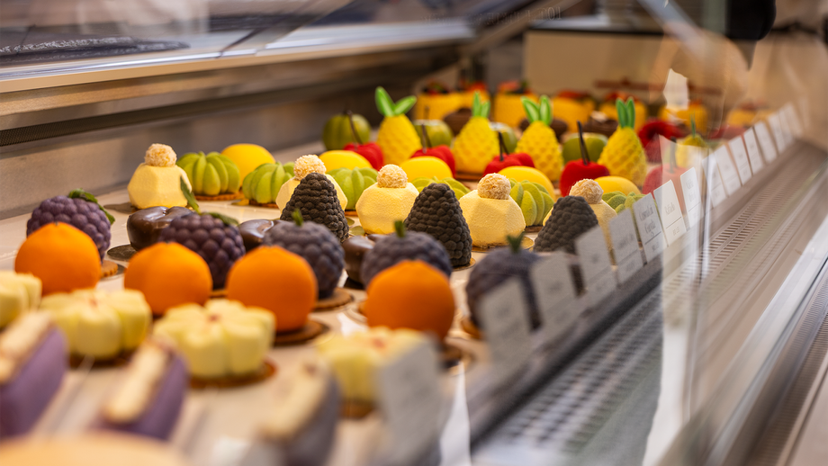 Colorful pastries and baked goods on a bakery display conveyor