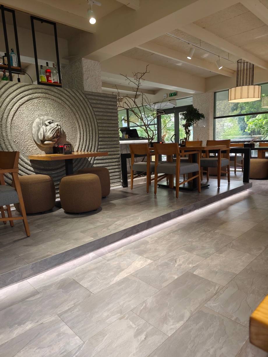 Modern spa or wellness lounge with neutral tones, geometric wall art, and contemporary furnishings