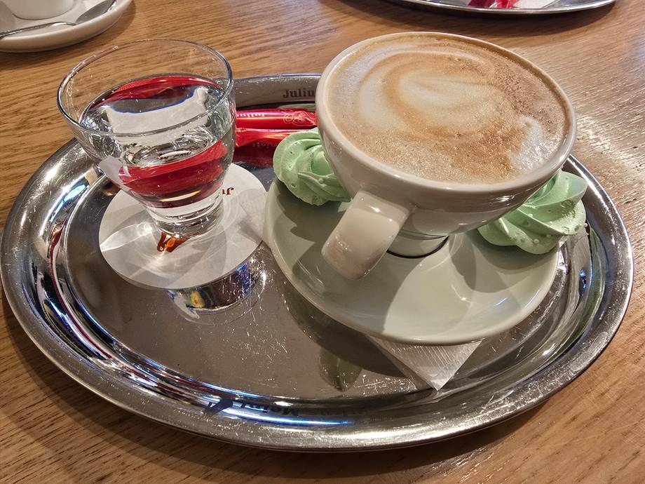 Beverage service with cappuccino and drink in cafe setting