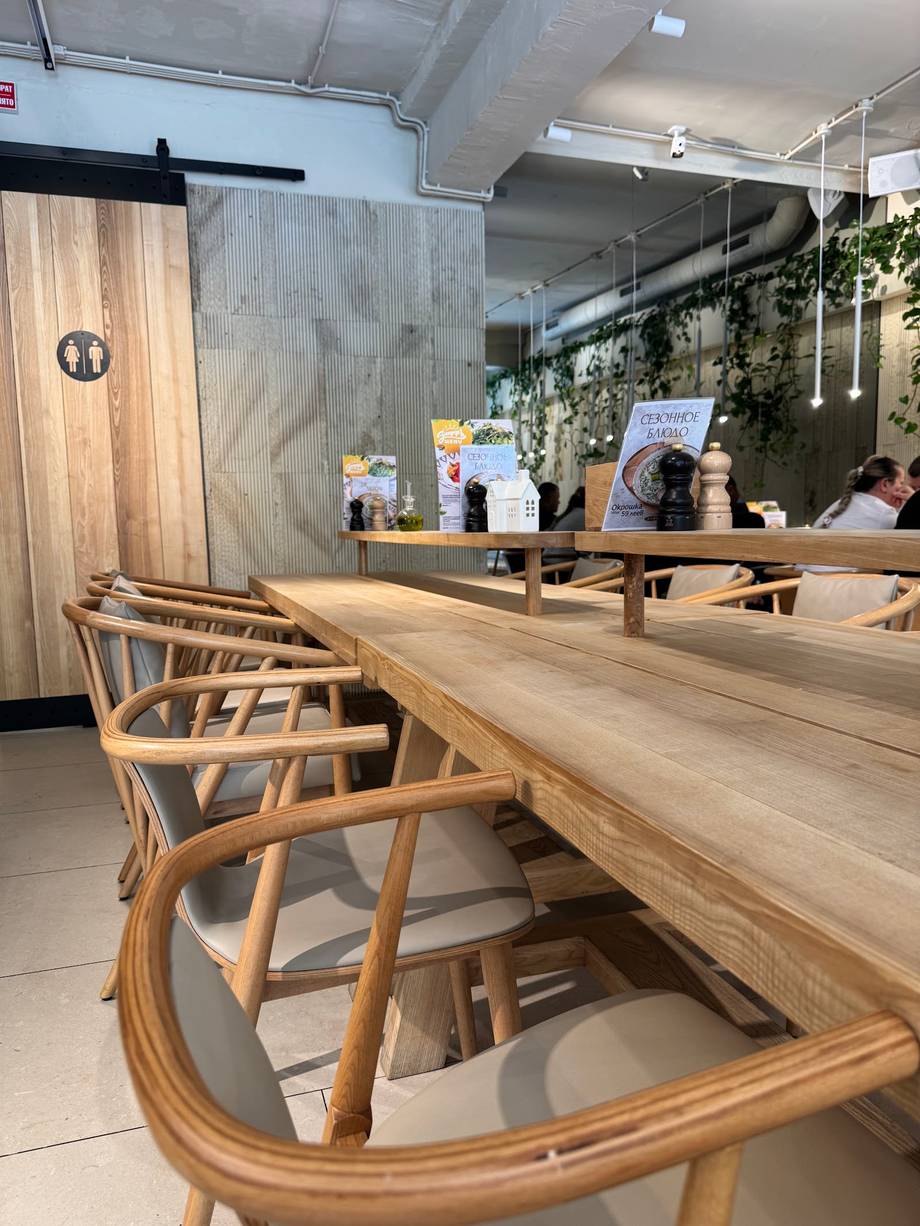 Modern cafe interior with wooden counter seating and contemporary design