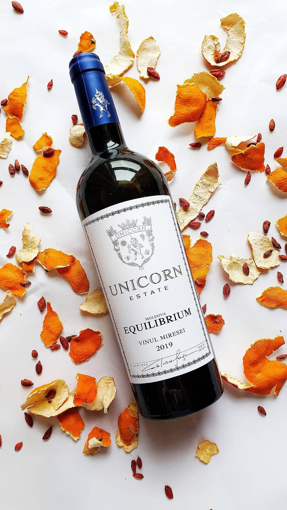 Unicorn Estate wine bottle with autumn-themed styling and dried citrus garnish