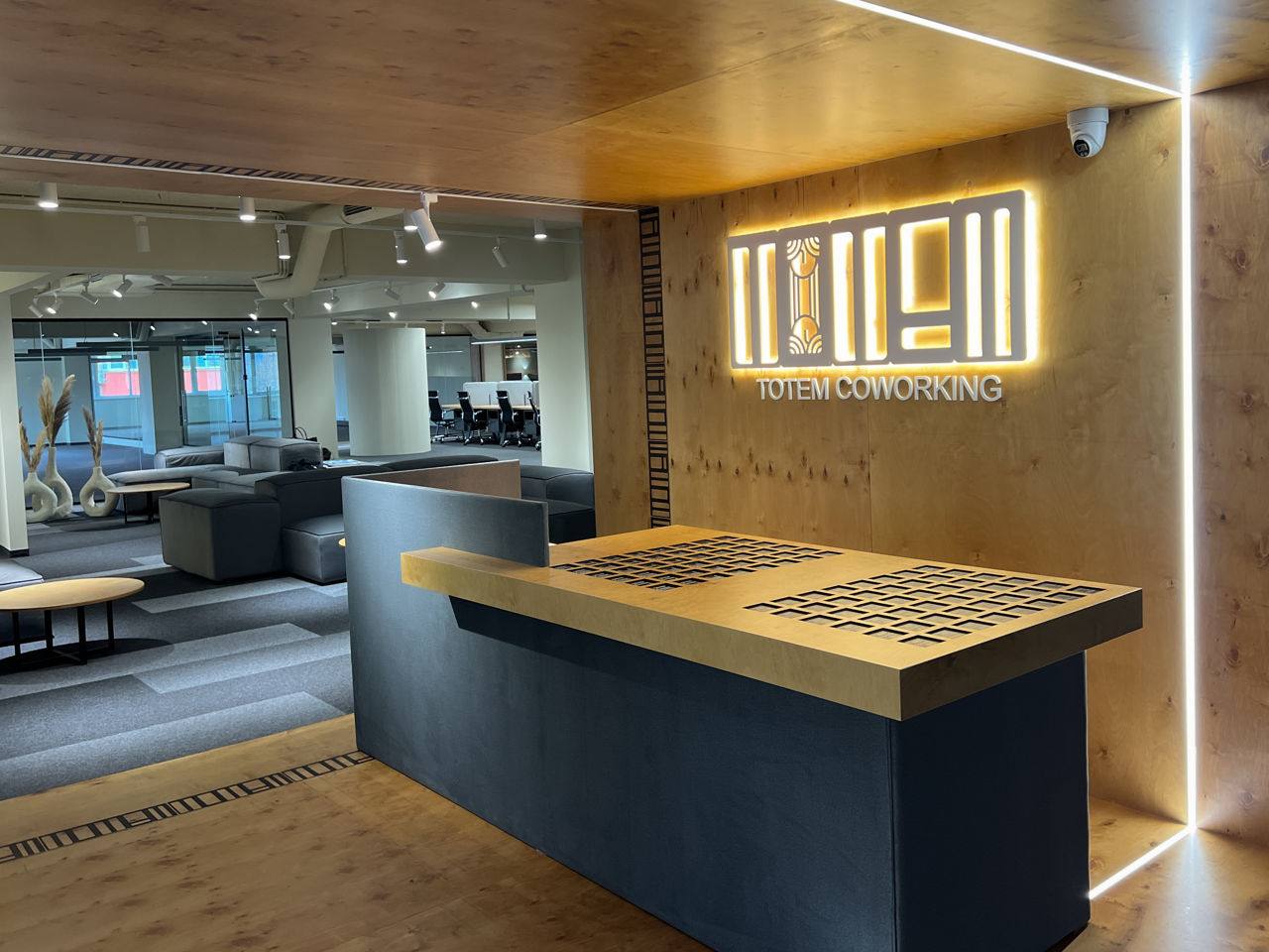 Modern sushi restaurant interior with illuminated brand signage and counter seating