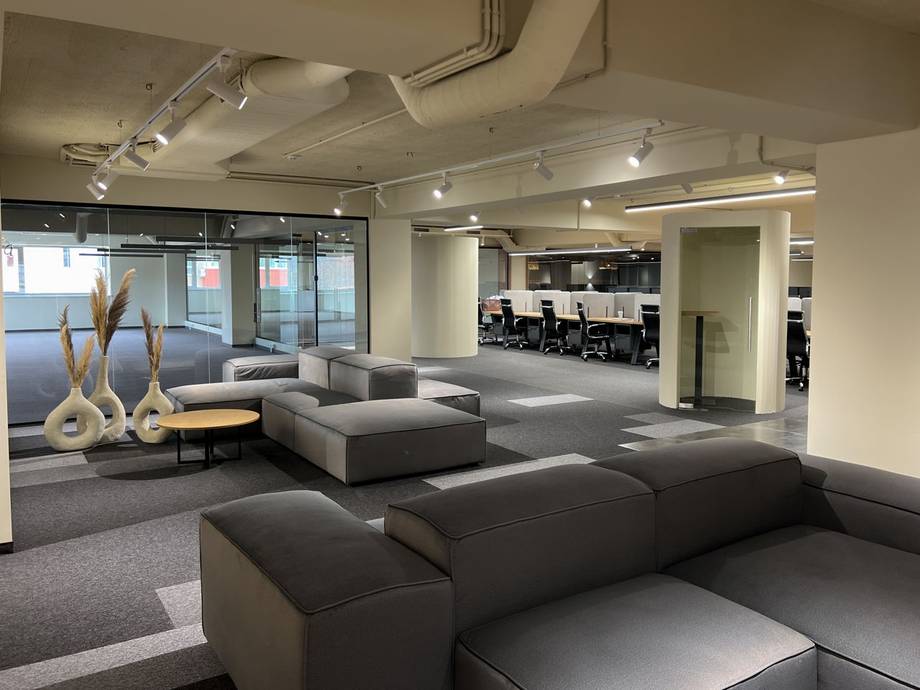 Modern lounge interior with modular seating, gymnastics rings, and professional lighting
