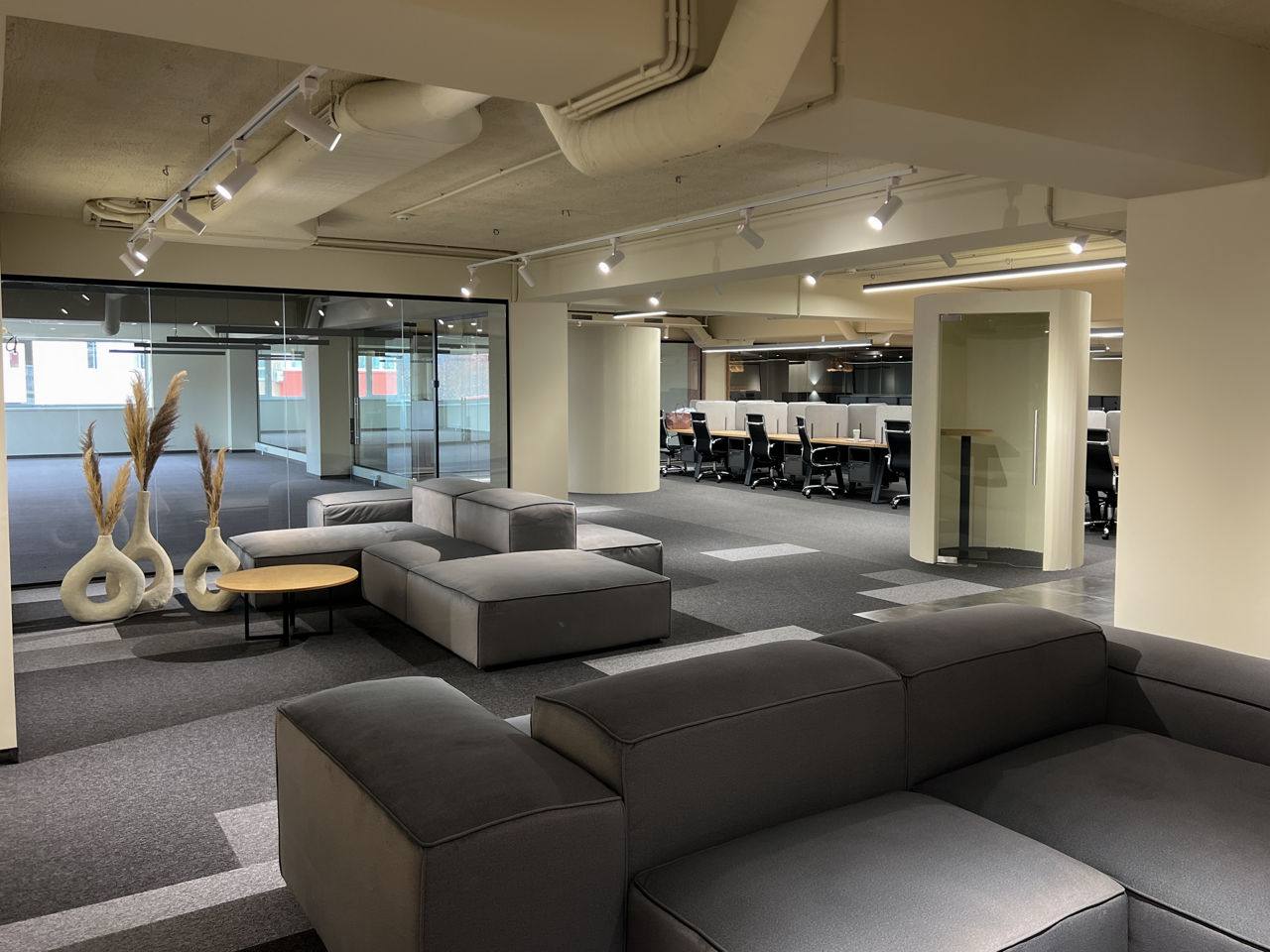 Modern lounge interior with modular seating, gymnastics rings, and professional lighting