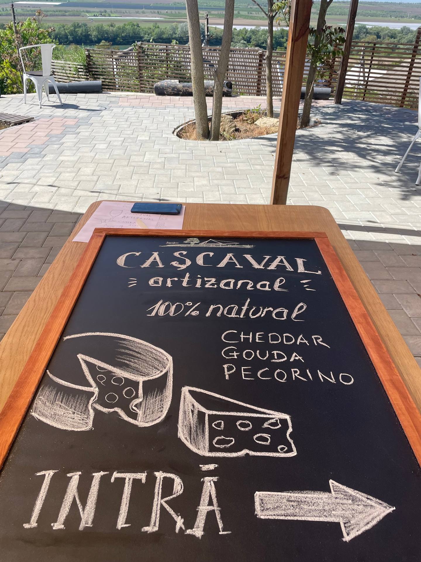 Cascaval artisanal cheese menu sign with terrace and countryside views