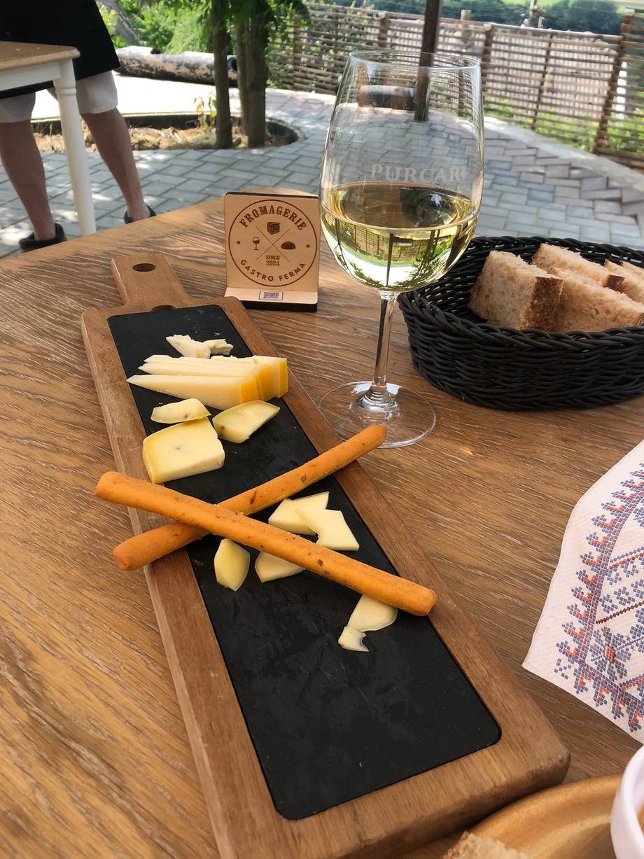 Wine and charcuterie board on terrace with bread and cheese selection