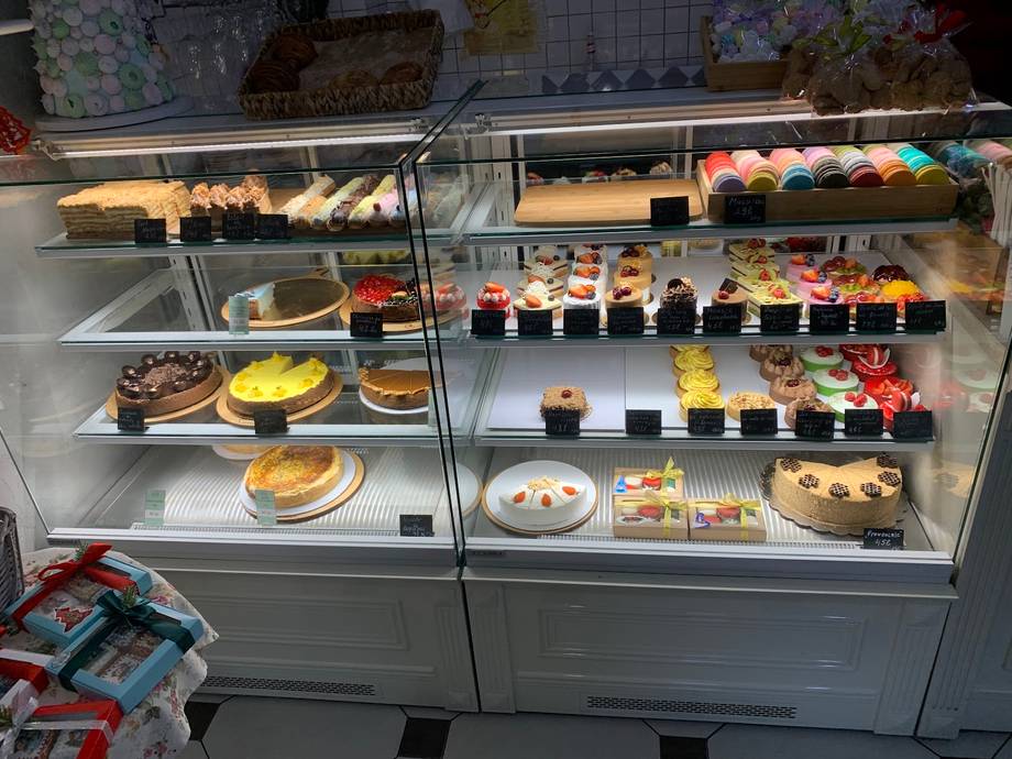 Bakery display case with pastries, cakes, and desserts