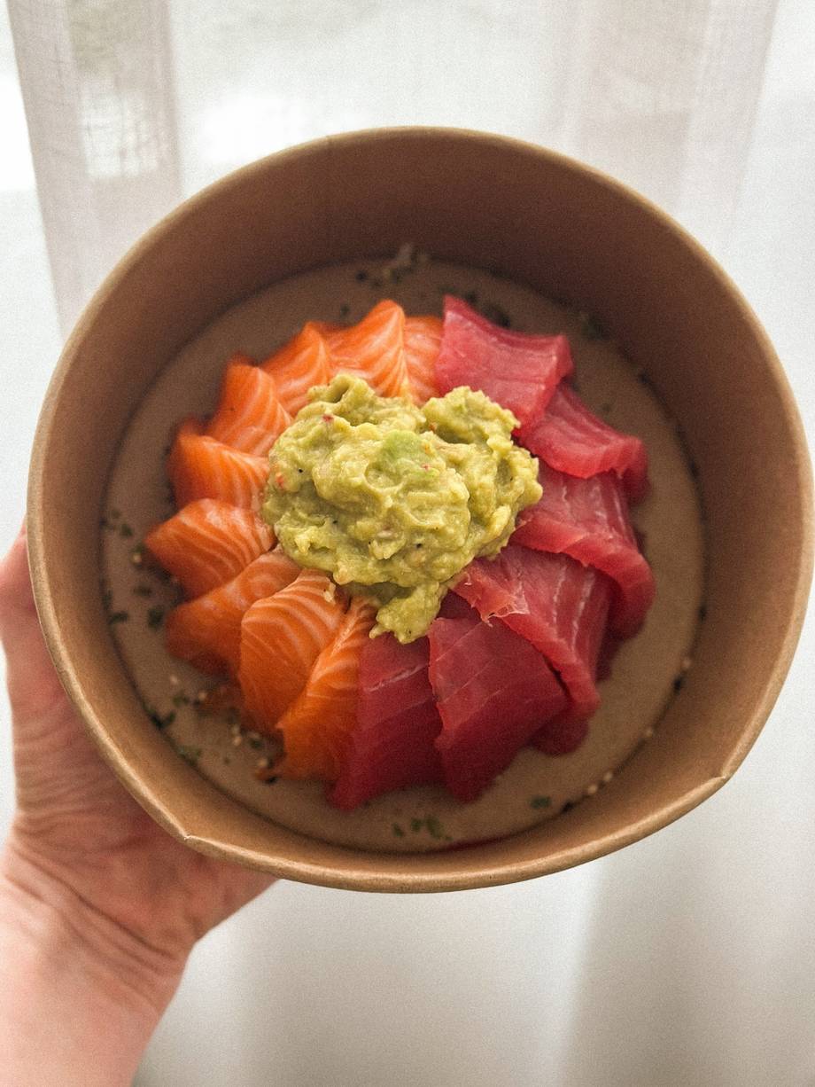 Poke bowl with salmon, tuna, avocado and sesame seeds