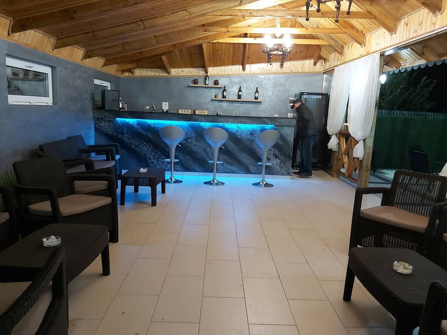 Interior space with activity area, blue flooring, and hospitality seating around perimeter