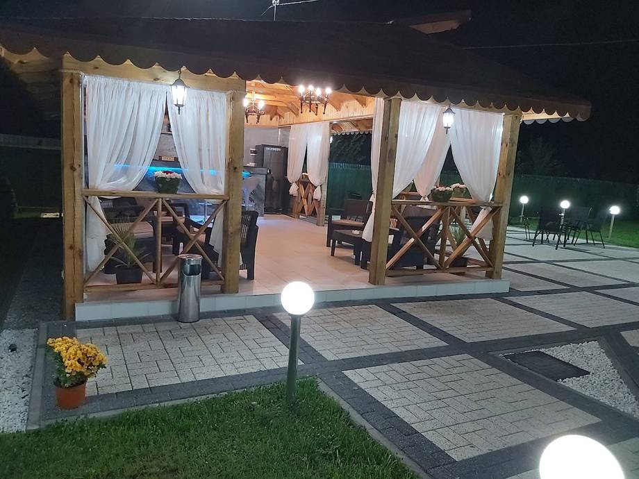 Evening terrace venue with elegant white fabric pavilions and ambient lighting