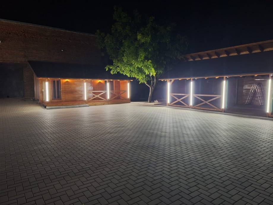 Exterior courtyard with event space gates and ambient lighting at night