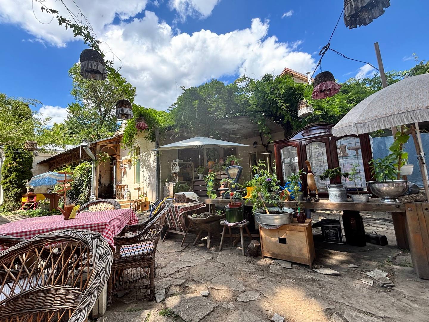 Bohemian outdoor terrace with wicker seating and handcrafted decor under natural light