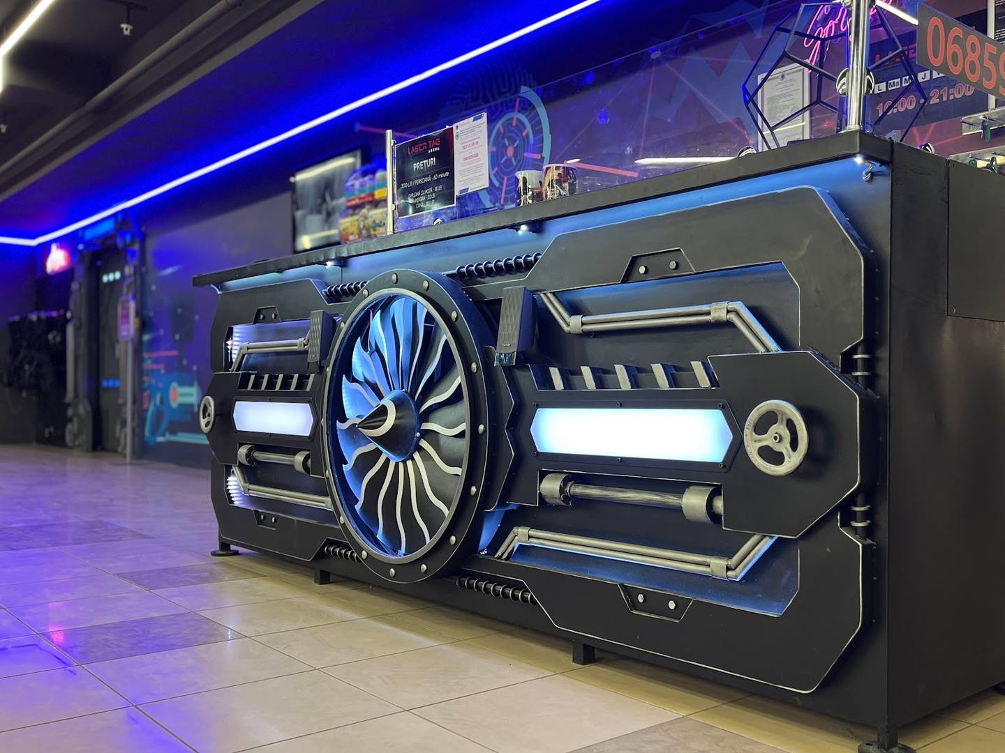 Interactive car customization display in gaming/entertainment venue with neon lighting